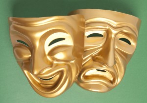 Comedy and Tragedy theatrical mask on a green background